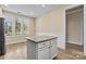 Eat-in kitchen features a granite-topped island, wood-look floors, and an abundance of natural light at 8121 Festival Way, Charlotte, NC 28215