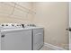 Bright laundry room featuring a white front-load washer and dryer and metal shelving at 8121 Festival Way, Charlotte, NC 28215