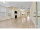 Spacious living room featuring a fireplace, large windows, and hardwood floors at 8121 Festival Way, Charlotte, NC 28215