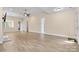 Spacious living room with wood-look floors and neutral paint is ready for your personal touches at 8121 Festival Way, Charlotte, NC 28215