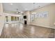 Open living room area with hardwood floors and natural light at 8121 Festival Way, Charlotte, NC 28215