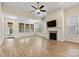 Spacious living area with fireplace, hardwood flooring, and abundant natural light at 8121 Festival Way, Charlotte, NC 28215
