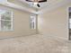 Comfortable main bedroom with neutral carpeting and views of the front yard at 8121 Festival Way, Charlotte, NC 28215