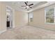 Spacious main bedroom boasts a tray ceiling, fan and an adjoining bathroom at 8121 Festival Way, Charlotte, NC 28215