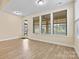 Light-filled sun room with an exterior door and a view of the private backyard at 8121 Festival Way, Charlotte, NC 28215