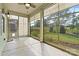 Bright sunroom with lots of windows offering views of the green backyard at 8121 Festival Way, Charlotte, NC 28215