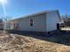 Side and rear view of gray sided home with covered porch and attached garage at 745 Grier St, Rock Hill, SC 29730