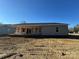 Rear view of a gray sided home with an unfinished porch and backyard at 745 Grier St, Rock Hill, SC 29730