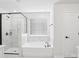 Elegant bathroom featuring marble walk-in shower, soaking tub, and a large window at 5108 Silver Creek Ln, Denver, NC 28037