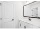 A well-lit bathroom has a modern vanity, a framed mirror, and a convenient door to another room at 5108 Silver Creek Ln, Denver, NC 28037
