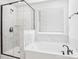 Bathroom with glass shower, soaking tub and marble tile at 5108 Silver Creek Ln, Denver, NC 28037