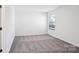 A well-lit bedroom offers a cozy retreat with its soft carpet and a window letting in natural light at 5108 Silver Creek Ln, Denver, NC 28037