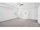 Spacious bedroom featuring tray ceilings, a ceiling fan, and a private bathroom entrance at 5108 Silver Creek Ln, Denver, NC 28037