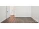 Bright, empty bedroom with hardwood floors, fresh paint, and doors at 5108 Silver Creek Ln, Denver, NC 28037