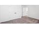 A bright bedroom features neutral walls, plush carpet, and a double door closet for ample storage at 5108 Silver Creek Ln, Denver, NC 28037