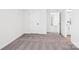 An open bedroom features neutral carpet, white walls, and a doorway to another room at 5108 Silver Creek Ln, Denver, NC 28037