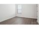 Bright, empty bedroom with hardwood floors, fresh paint, and a window with blinds at 5108 Silver Creek Ln, Denver, NC 28037