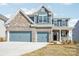 Beautiful two-story home with a two-car garage and brick and siding exterior at 5108 Silver Creek Ln, Denver, NC 28037