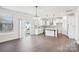 Open concept kitchen with white cabinets, stainless steel appliances, and a center island at 5108 Silver Creek Ln, Denver, NC 28037