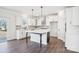 Modern kitchen with white cabinets, stainless steel appliances, and island with dark accents at 5108 Silver Creek Ln, Denver, NC 28037