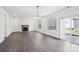 Spacious living room featuring hardwood floors, a fireplace, and large windows at 5108 Silver Creek Ln, Denver, NC 28037