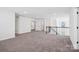 Open living room featuring neutral carpet, recessed lighting and several doorways at 5108 Silver Creek Ln, Denver, NC 28037