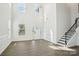 Bright living room featuring hardwood floors, high ceilings, and a staircase at 5108 Silver Creek Ln, Denver, NC 28037