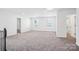 Open living room featuring neutral carpet, recessed lighting and several windows at 5108 Silver Creek Ln, Denver, NC 28037