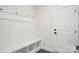Mudroom with built-in bench, coat hooks, shelves and hardwood style flooring at 5108 Silver Creek Ln, Denver, NC 28037