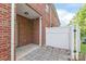 Brick patio with a white fence and access to the back of the house at 1002 Tj Dr, Monroe, NC 28112