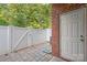 Private patio with brick wall, pavers, and a white fence at 1002 Tj Dr, Monroe, NC 28112