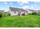 Wide angle view of a backyard with lush green grass, patio, and black metal fence at 4280 Stream Dale Cir, Concord, NC 28027
