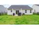 Spacious backyard with lush green grass, patio, and black metal fence at 4280 Stream Dale Cir, Concord, NC 28027