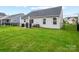 Spacious backyard with lush green grass, patio, and black metal fence at 4280 Stream Dale Cir, Concord, NC 28027