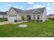 Charming single-story home with well-manicured lawn, stone accents, and attached garage, offering great curb appeal at 4280 Stream Dale Cir, Concord, NC 28027