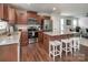 Well-lit kitchen boasts stainless steel appliances, granite countertops, and a convenient center island with bar stool seating at 4280 Stream Dale Cir, Concord, NC 28027