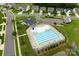 Aerial view of a community pool with a clubhouse, lounge chairs, and well-maintained landscaping at 4280 Stream Dale Cir, Concord, NC 28027