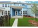 A cozy backyard patio and green grass with black metal fencing at 10507 Boudreaux St, Huntersville, NC 28078