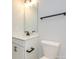 Bathroom featuring a white vanity, black hardware, and a sleek mirror at 10507 Boudreaux St, Huntersville, NC 28078