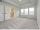 Main bedroom with grey carpet, large windows, and ensuite bathroom at 10507 Boudreaux St, Huntersville, NC 28078