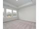 Bright bedroom featuring grey carpet and three large windows at 10507 Boudreaux St, Huntersville, NC 28078