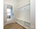 Entryway with built-in bench, hooks, and closet at 10507 Boudreaux St, Huntersville, NC 28078