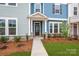 Charming exterior view of a two-story home featuring a covered porch and well-manicured lawn at 10507 Boudreaux St, Huntersville, NC 28078
