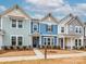 Three townhouses in a row with varying siding colors at 10507 Boudreaux St, Huntersville, NC 28078