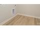 Neutral hallway with simple baseboard trim and light wood flooring at 10507 Boudreaux St, Huntersville, NC 28078