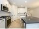 Modern kitchen with stainless steel appliances and a large island at 10507 Boudreaux St, Huntersville, NC 28078