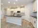 Modern kitchen with white shaker cabinets, dark countertops, and a large island at 10507 Boudreaux St, Huntersville, NC 28078