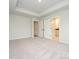 Minimalist bedroom with a light gray carpet, and en-suite bathroom offering a peaceful retreat at 10507 Boudreaux St, Huntersville, NC 28078