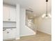 View of staircase leading upstairs from kitchen area at 10507 Boudreaux St, Huntersville, NC 28078