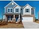 Two-story house with gray and beige siding, a two-car garage, and a front porch at 1805 Augustine St, Monroe, NC 28112